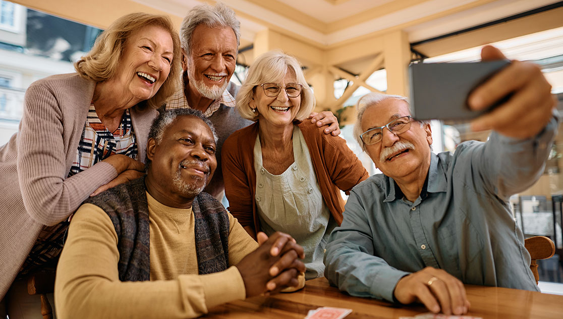 group of senior friends taking a group selfie